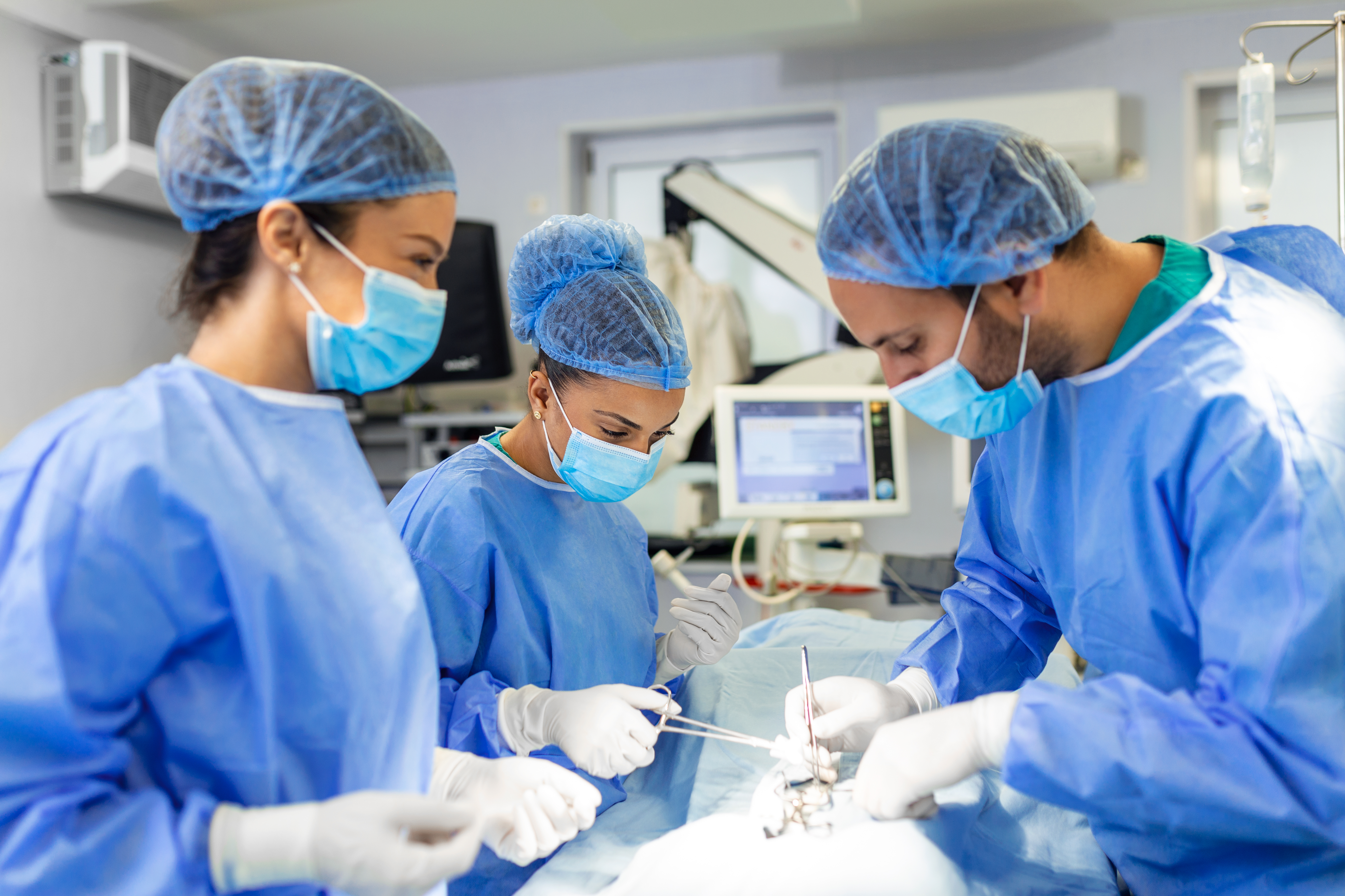 group-surgeons-doing-surgery-hospital-operating-theater-medical-team-doing-critical-operation-group-surgeons-operating-room-with-surgery-equipment-modern-medical-background(1)